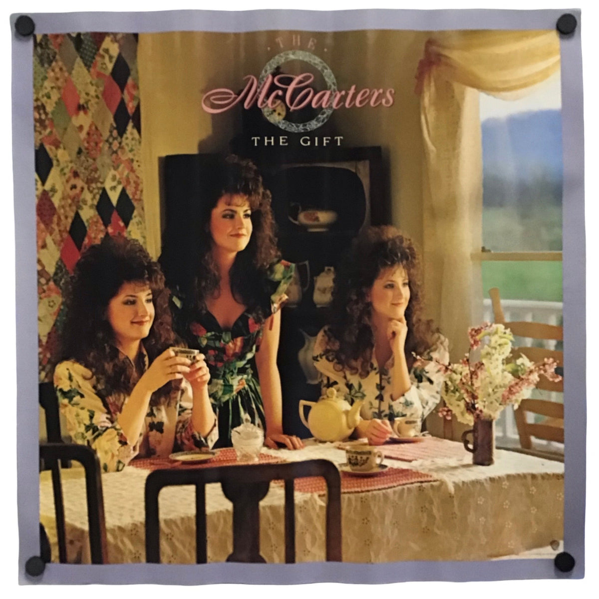 A square wall tapestry featuring the album cover art for 'The Gift' by the band McCartneys. The tapestry is displayed flat against a white background, secured with four black grommets in the corners.