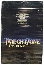 A vintage movie poster for 'Twilight Zone The Movie' with a dark starry sky background, large gold title text, and credits at the bottom, photographed flat against a light neutral background.