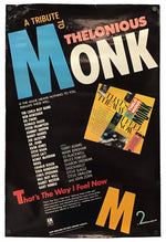 A vintage-style concert poster for 'A Tribute to the Thelonious Monk' hangs against a plain white background. The poster is predominantly black with large blue, white, orange, and yellow typography, plus a small inset album cover graphic.