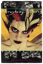 A vintage-style poster or print featuring a close-up portrait of a woman with dramatic stylized feathers and the title text 'Thrashing Doves' across the top. The artwork has a yellow background, black-and-white top and bottom panels, and a multicolored central face and feather design.